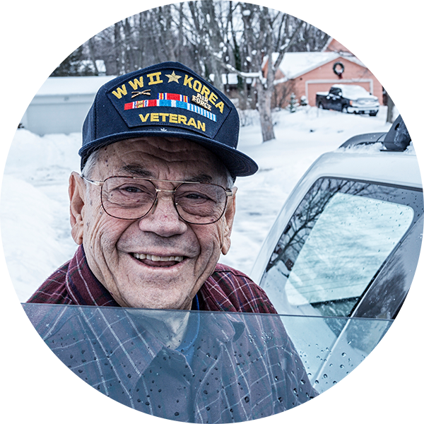 Veteran next to his car